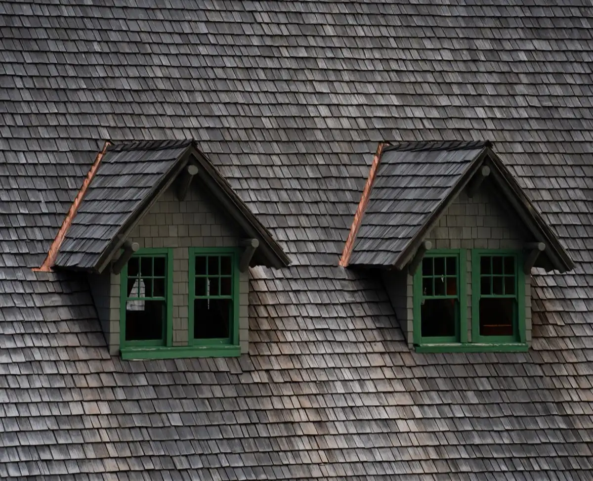 Dormers on a shingle roof in Kingman, AZ, where step flashing and kickout flashing carry water past the walls